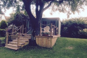 Wooden summer house with decking and steps