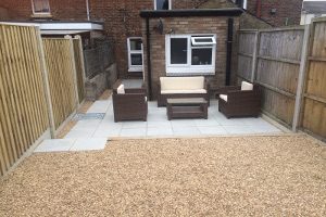 Patio with decorative slabs and gravel with stylish sofa